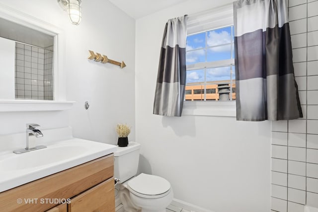 bathroom featuring toilet and vanity