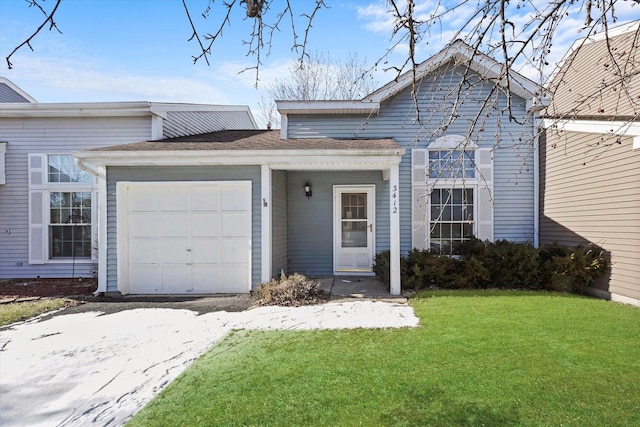 single story home featuring a garage and a front lawn