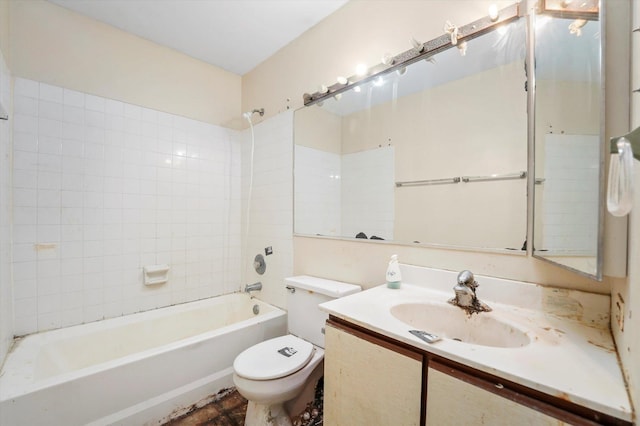 full bathroom with tiled shower / bath, vanity, and toilet