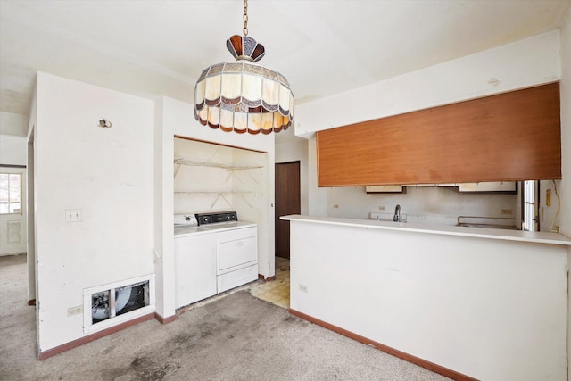 kitchen with light carpet, decorative backsplash, and washer and clothes dryer