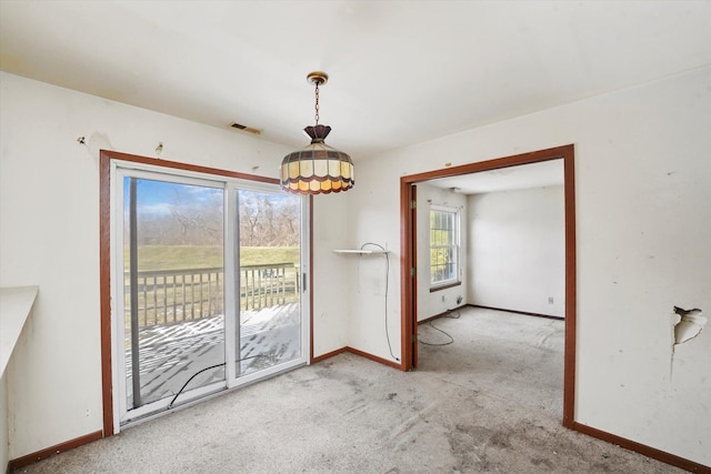 unfurnished dining area with light carpet