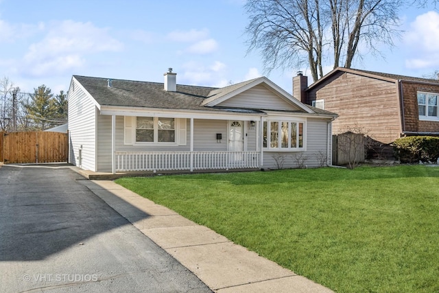 ranch-style home with covered porch and a front lawn