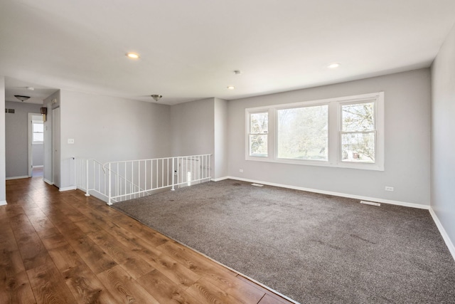 spare room with dark hardwood / wood-style flooring