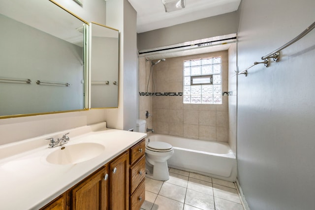 full bathroom featuring tiled shower / bath, tile patterned floors, toilet, and vanity