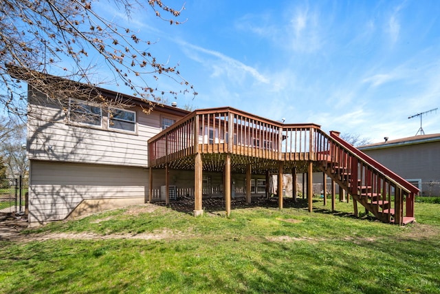 back of house featuring a wooden deck and a yard