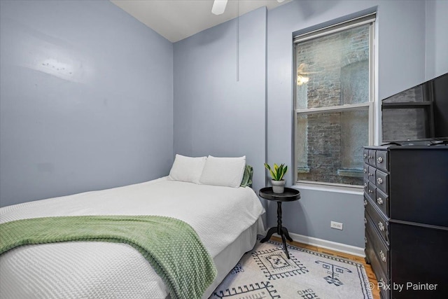 bedroom featuring ceiling fan and light hardwood / wood-style flooring