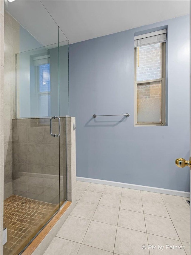 bathroom with tile patterned flooring and walk in shower