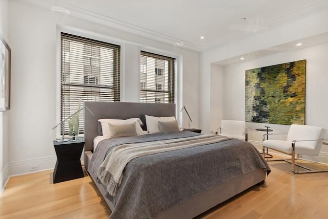 bedroom featuring ornamental molding and wood-type flooring