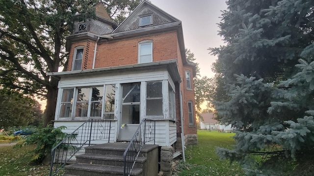 view of back house at dusk