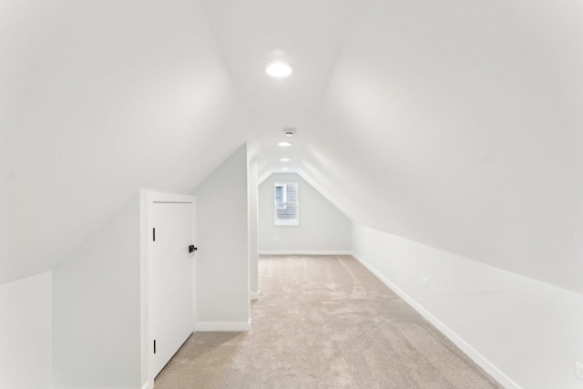 additional living space with light carpet, recessed lighting, baseboards, and lofted ceiling