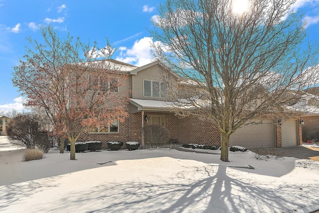 traditional home with an attached garage, driveway, and brick siding