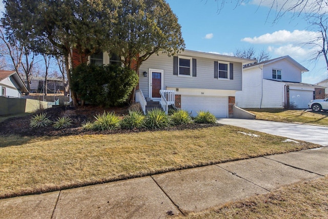 bi-level home with a front yard, brick siding, driveway, and fence