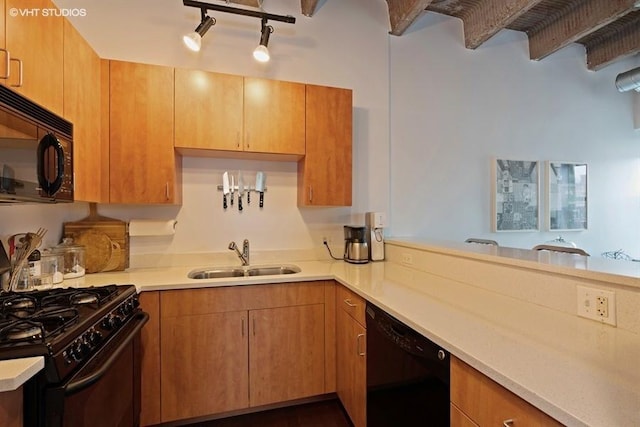 kitchen featuring sink, black appliances, and kitchen peninsula