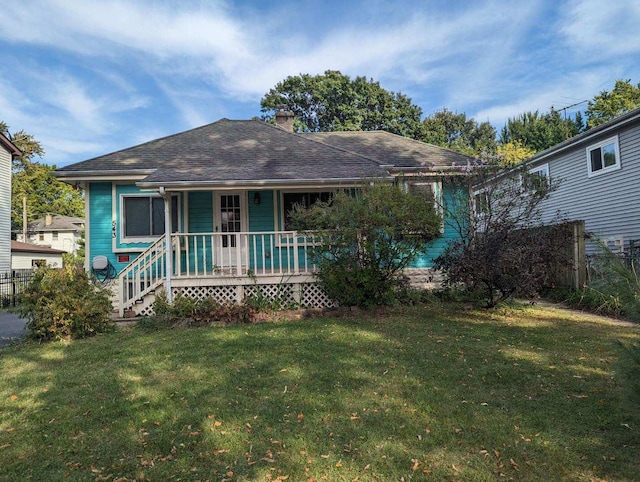 view of front of house with a porch and a front yard