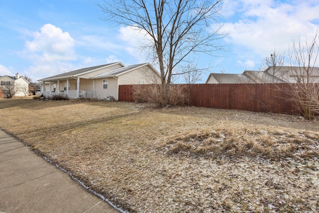 view of side of home featuring fence