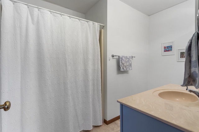 full bath with vanity and baseboards