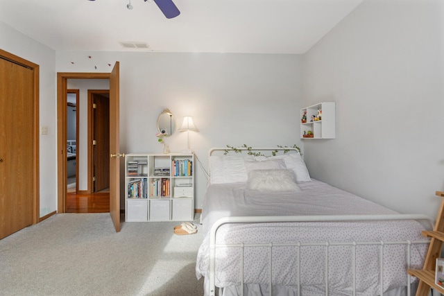 bedroom with visible vents, ceiling fan, and carpet flooring