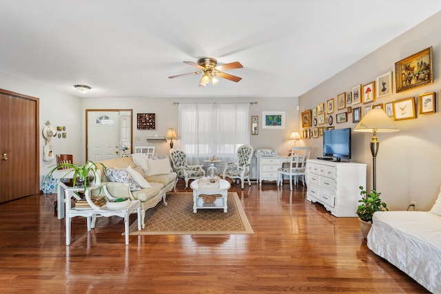 living room featuring wood finished floors and a ceiling fan