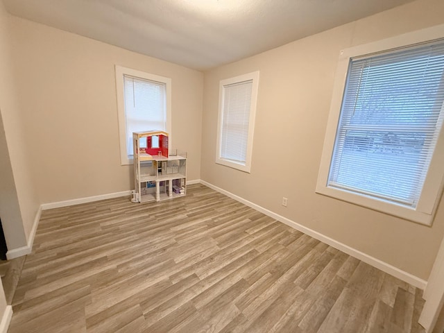 unfurnished room with light wood-type flooring