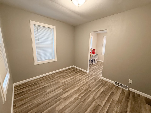 empty room with hardwood / wood-style floors