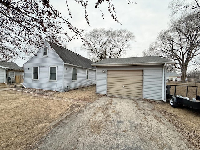 exterior space featuring a garage and an outdoor structure