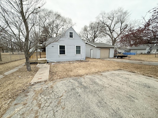 view of front facade with a garage and an outbuilding