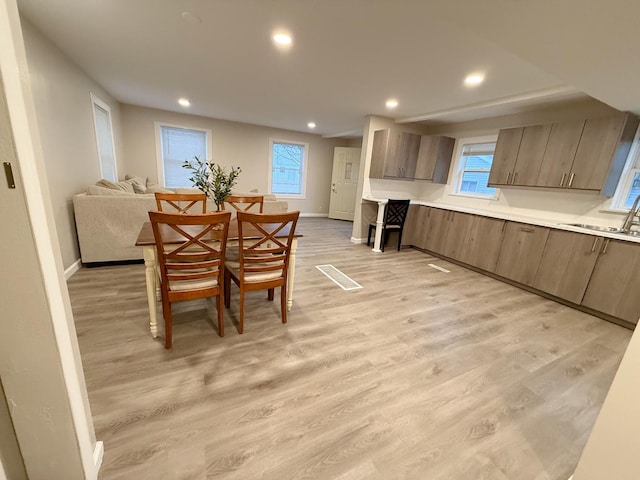 dining room with sink and light wood-type flooring