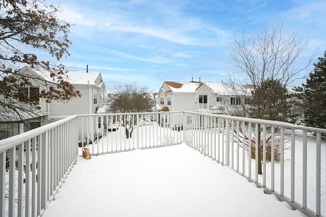 snow covered deck featuring a residential view