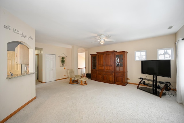 living area with baseboards, visible vents, and carpet flooring