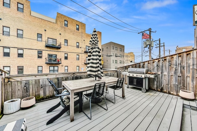 wooden deck featuring a grill