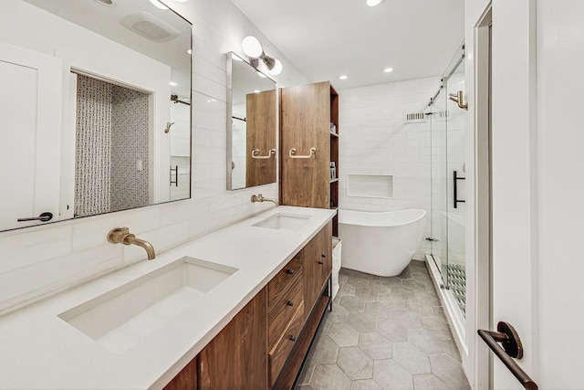 bathroom with vanity, independent shower and bath, and tile walls