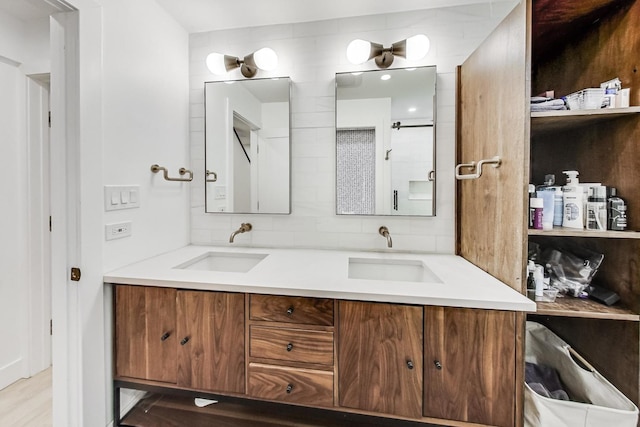 bathroom featuring tasteful backsplash and vanity