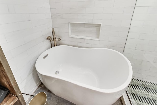 bathroom featuring a tub and tile walls