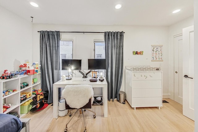 office area with light hardwood / wood-style floors