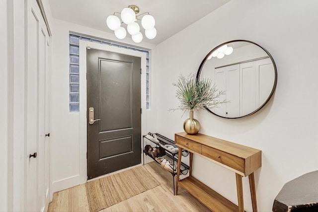 entryway featuring an inviting chandelier and light wood-type flooring