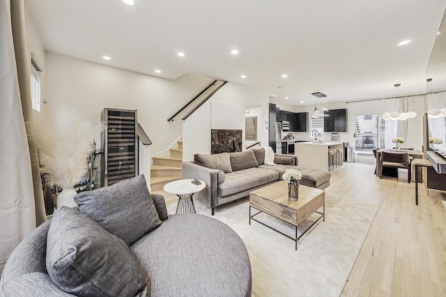 living room with light hardwood / wood-style flooring and beverage cooler