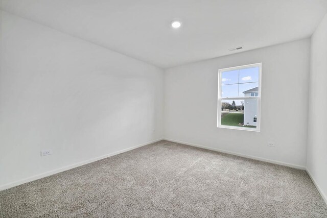 empty room with baseboards, a wealth of natural light, and carpet