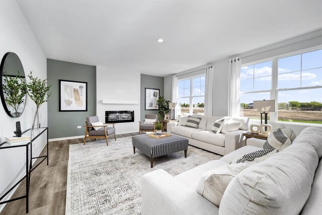 living room with light wood finished floors and recessed lighting
