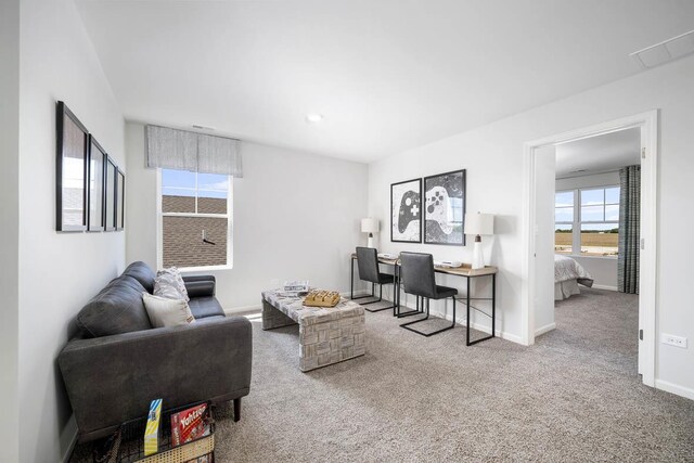bedroom with visible vents, baseboards, and light carpet
