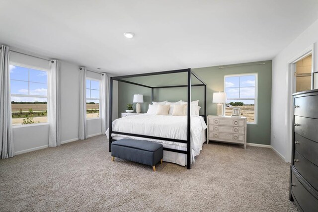 bedroom featuring carpet and baseboards