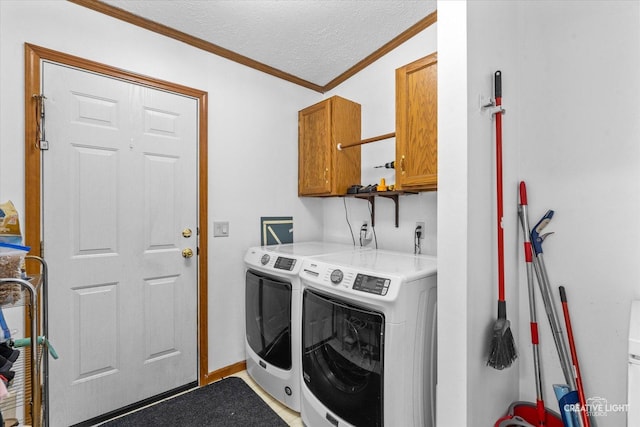 clothes washing area featuring separate washer and dryer, crown molding, cabinets, and a textured ceiling