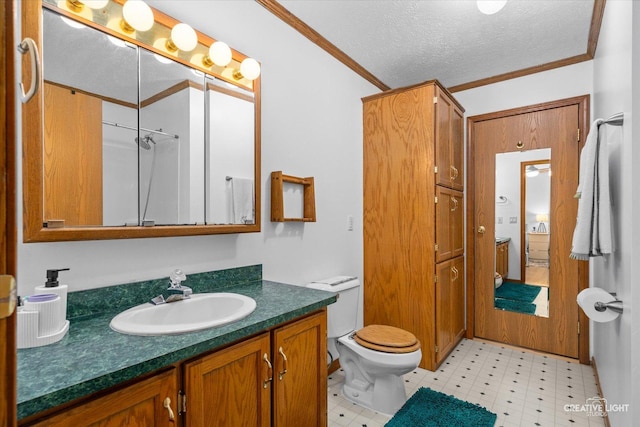 bathroom featuring crown molding, vanity, a textured ceiling, and toilet