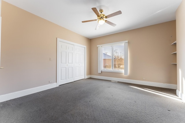 unfurnished bedroom with ceiling fan, a closet, and carpet