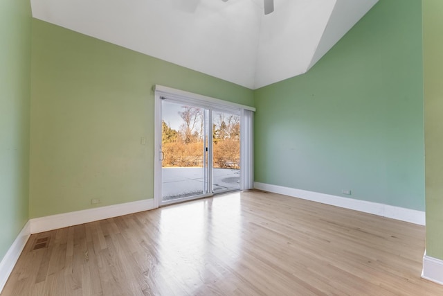 unfurnished room featuring ceiling fan, high vaulted ceiling, and light wood-type flooring