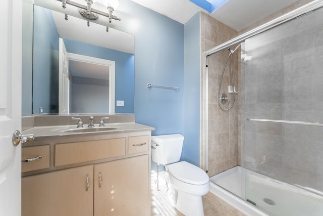 bathroom with an enclosed shower, vanity, tile patterned floors, and toilet