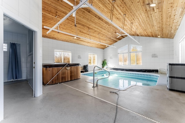 view of swimming pool featuring a hot tub