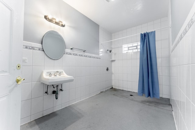 bathroom featuring sink, tile walls, concrete floors, and a shower with curtain