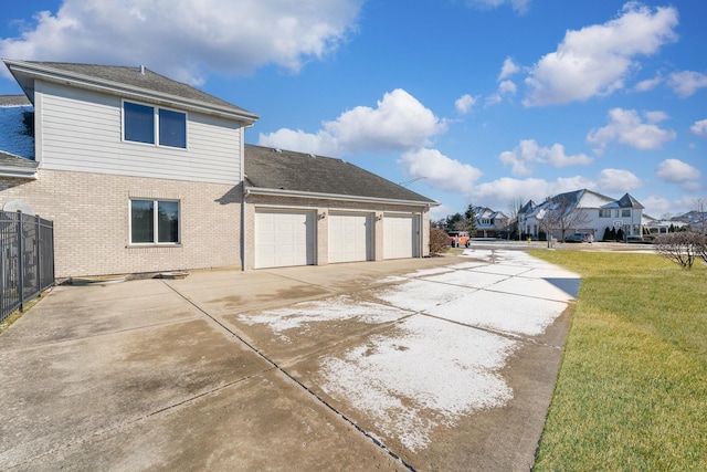 view of property exterior featuring a garage and a yard