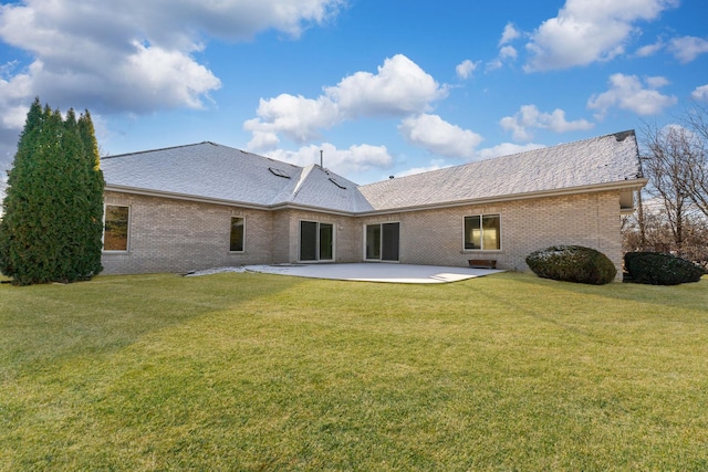 back of property with a patio and a yard