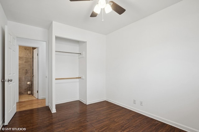 unfurnished bedroom with dark wood-type flooring, a closet, and ceiling fan